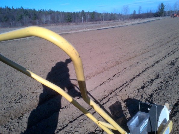 This photo was taken on April 6, 2012. I posted it to Facebook with the caption: An awesome start to the 2012 planting season today: seeded peas, carrots, spinach, Swiss chard, mesclun, dandelion, faba beans, turnips, radishes, and parsnips. I covered about 5km with the push seeder in total, and never went more than 500 feet from the house!